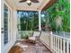 Relaxing back porch with brick floor and wicker chair at 2501 N Dundee St, Tampa, FL 33629