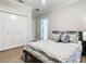 Guest bedroom with a queen-size bed and double doors leading to the bathroom at 2501 N Dundee St, Tampa, FL 33629