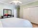 Bedroom with a queen-size bed, ceiling fan, and double doors at 2501 N Dundee St, Tampa, FL 33629