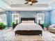 Spacious bedroom with large bed, two nightstands, and a ceiling fan at 2501 N Dundee St, Tampa, FL 33629