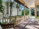 Inviting front porch with brick flooring and wicker chairs at 2501 N Dundee St, Tampa, FL 33629