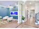 Spacious sitting area with white armchairs, a glass coffee table, and a built-in fish tank at 2501 N Dundee St, Tampa, FL 33629