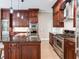 Spacious kitchen with stainless steel appliances, granite countertops, and dark wood cabinets at 2501 N Dundee St, Tampa, FL 33629