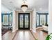 Elegant entryway with double doors, hardwood floors, and a crystal chandelier at 2501 N Dundee St, Tampa, FL 33629