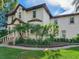 Two-story home with palm trees, brick walkway, and double front doors at 2501 N Dundee St, Tampa, FL 33629