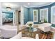Comfortable sitting area with white armchairs, a glass-top coffee table, and an area rug at 2501 N Dundee St, Tampa, FL 33629