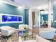 Bright sitting area with white armchairs and a large built-in fish tank at 2501 N Dundee St, Tampa, FL 33629