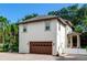 Attached two-car garage with brown door and paver driveway at 2501 N Dundee St, Tampa, FL 33629