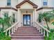 Elegant entryway with double doors and brick steps, framed by columns and palm trees at 2501 N Dundee St, Tampa, FL 33629