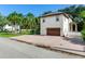 Two-car garage with brick driveway and landscaping at 2501 N Dundee St, Tampa, FL 33629