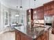 Kitchen features granite island, breakfast nook, and custom cabinetry at 2501 N Dundee St, Tampa, FL 33629