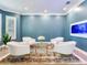 Relaxing sitting area featuring four white armchairs and an area rug at 2501 N Dundee St, Tampa, FL 33629