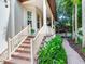 Steps leading to front porch with lush landscaping at 2501 N Dundee St, Tampa, FL 33629