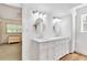 Double vanity bathroom with modern lighting and mirrors at 2511 Dolly Bay Dr # 301, Palm Harbor, FL 34684