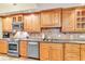 Kitchen with wood cabinets, granite counters, and stainless steel appliances at 2511 Dolly Bay Dr # 301, Palm Harbor, FL 34684