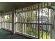 Enjoy the tranquil wooded views from this screened porch at 2511 Dolly Bay Dr # 301, Palm Harbor, FL 34684