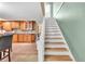 Elegant staircase leading to the upper level, overlooking the kitchen at 2511 Dolly Bay Dr # 301, Palm Harbor, FL 34684