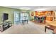 Bright living room with access to a screened balcony and neutral carpeting at 2511 Dolly Bay Dr # 301, Palm Harbor, FL 34684