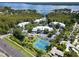 Aerial view of a community with tennis courts, pond, and waterfront access at 2511 Dolly Bay Dr # 301, Palm Harbor, FL 34684