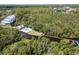 Aerial view of community with a pool, dock, and lush landscaping at 2511 Dolly Bay Dr # 301, Palm Harbor, FL 34684