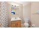 Bathroom featuring tile floors, single sink vanity with drawers, large mirror and a shower/tub combo at 13049 Thoroughbred Dr, Dade City, FL 33525
