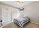 Comfortable bedroom with neutral walls, plush carpet, and a cozy bed topped with a patterned blanket at 13049 Thoroughbred Dr, Dade City, FL 33525
