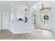 Bright foyer featuring wood-look tile flooring, arched doorways, and a decorative chandelier at 13049 Thoroughbred Dr, Dade City, FL 33525