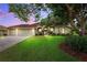 Charming single Gathering home with a well-manicured lawn, mature landscaping, and a two car garage at 13049 Thoroughbred Dr, Dade City, FL 33525