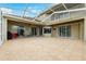 Covered lanai with neutral tile, ceiling fan, and views of the lush landscaping and outdoor space at 13049 Thoroughbred Dr, Dade City, FL 33525