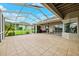 The lanai features a screened-in enclosure with tile flooring, a ceiling fan, and neutral exterior walls at 13049 Thoroughbred Dr, Dade City, FL 33525