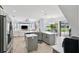 Open concept kitchen and living room with stainless appliances, island, and hardwood floors at 13049 Thoroughbred Dr, Dade City, FL 33525