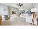 Open concept living room featuring hardwood floors, a ceiling fan, and sliding glass doors to the patio at 13049 Thoroughbred Dr, Dade City, FL 33525