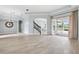 Spacious living room featuring tile floors, tray ceilings, neutral walls, and sliding glass doors at 13049 Thoroughbred Dr, Dade City, FL 33525