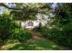 Landscaped backyard with a serene path and lush foliage at 3111 Arrowsmith Rd, Wimauma, FL 33598