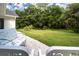 Spacious backyard with lush greenery, string lights, and seating area at 3111 Arrowsmith Rd, Wimauma, FL 33598