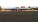 Long stable barn with metal roof at 3111 Arrowsmith Rd, Wimauma, FL 33598