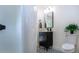 Clean bathroom, featuring a dark vanity and patterned floor at 3111 Arrowsmith Rd, Wimauma, FL 33598