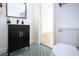 Clean bathroom with black vanity and patterned floor at 3111 Arrowsmith Rd, Wimauma, FL 33598
