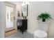 Small bathroom with patterned floor and exterior access at 3111 Arrowsmith Rd, Wimauma, FL 33598