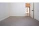 Simple bedroom with carpet flooring and access to hallway at 3111 Arrowsmith Rd, Wimauma, FL 33598