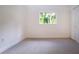 Simple bedroom with carpet, window and closet at 3111 Arrowsmith Rd, Wimauma, FL 33598
