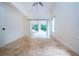 Bright bedroom with tile floors and sliding glass doors at 3111 Arrowsmith Rd, Wimauma, FL 33598