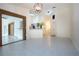 Open dining area with tile floors and access to the kitchen at 3111 Arrowsmith Rd, Wimauma, FL 33598
