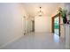 Bright dining room with tile floors and an elegant light fixture at 3111 Arrowsmith Rd, Wimauma, FL 33598