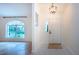 Spacious entryway with a view into the living room and natural light at 3111 Arrowsmith Rd, Wimauma, FL 33598