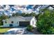 Single car garage with a driveway and landscaping at 3111 Arrowsmith Rd, Wimauma, FL 33598