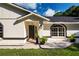 Updated exterior with a welcoming entrance and attractive landscaping at 3111 Arrowsmith Rd, Wimauma, FL 33598