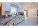 Updated kitchen with white cabinets, granite counters, and stainless steel appliances at 3111 Arrowsmith Rd, Wimauma, FL 33598