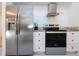 Sleek kitchen with stainless steel appliances and white cabinetry at 3111 Arrowsmith Rd, Wimauma, FL 33598
