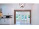 Modern kitchen with white cabinets and a view to the backyard at 3111 Arrowsmith Rd, Wimauma, FL 33598